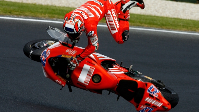 PHILLIP ISLAND, VICTORIA - OCTOBER 13:  Casey Stoner of Australia and the Ducati Team crashes during free practice for the 2007 Australian Motorcycle Grand Prix at the Phillip Island Circuit on October 13, 2007 in Phillip Island, Australia.  (Photo by Andrew Northcott/Getty Images)