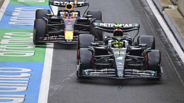 Mercedes driver Lewis Hamilton of Britain, right, and Red Bull driver Max Verstappen of the Netherlands steers his cars before the qualifying session at the British Formula One Grand Prix at the Silverstone racetrack, Silverstone, England, Saturday, July 8, 2023. The British Formula One Grand Prix will be held on Sunday. (Christian Bruna/Pool photo via AP)