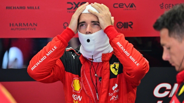 Ferrari's Monegasque driver Charles Leclerc puts on his balaclava as he prepares for the qualifying session at the Hungaroring race track in Mogyorod near Budapest on July 22, 2023, ahead of the Formula One Hungarian Grand Prix. (Photo by MARTON MONUS / POOL / AFP)