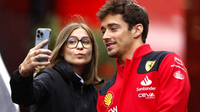 SPA, BELGIUM - JULY 27: Charles Leclerc of Monaco and Ferrari poses for a selfie with a fan during previews ahead of the F1 Grand Prix of Belgium at Circuit de Spa-Francorchamps on July 27, 2023 in Spa, Belgium. (Photo by Francois Nel/Getty Images)