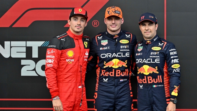 Fastest lap winner Red Bull Racing's Dutch driver Max Verstappen (C), second-placed Ferrari's Monegasque driver Charles Leclerc (L) and third-placed Red Bull Racing's Mexican driver Sergio Perez pose in the parc ferme after the qualifying session of the Formula One Belgian Grand Prix at the Spa-Francorchamps Circuit in Spa on July 28, 2023. (Photo by JOHN THYS / AFP)