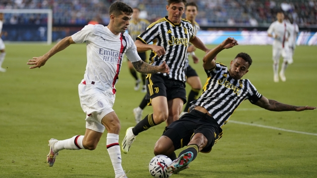 Juventus FC defender Luiz Da Silva Danilo, right, takes control of the ball from AC Milan forward Christian Pulisic, left, during the first half of a club friendly soccer match in Carson, Calif., Thursday, July 27, 2023. (AP Photo/Ashley Landis)