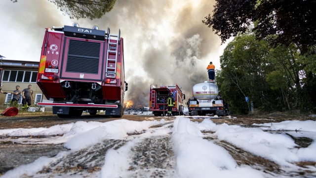 Firefighters in action to extinguish the fire of some waste near Ciampino airport, Rome, Italy, 29 July 2023. The flights are currently regular despite the column of smoke from the fire.    ANSA / MASSIMO PERCOSSI