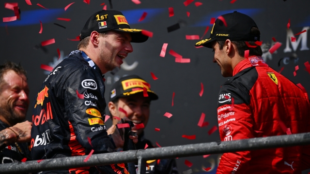 SPA, BELGIUM - JULY 30: Race winner Max Verstappen of the Netherlands and Oracle Red Bull Racing and Third placed Charles Leclerc of Monaco and Ferrari share a joke on the podium during the F1 Grand Prix of Belgium at Circuit de Spa-Francorchamps on July 30, 2023 in Spa, Belgium. (Photo by Dan Mullan/Getty Images)