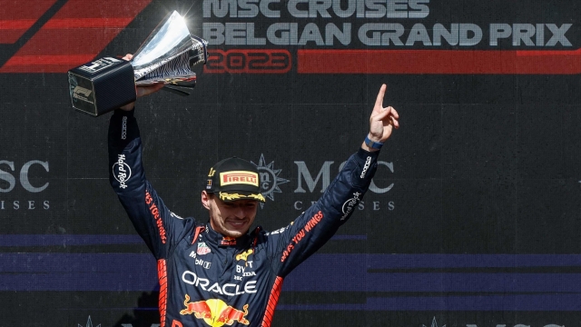 Red Bull Racing's Dutch driver Max Verstappen celebrates with his trophy on the podium after the Formula One Belgian Grand Prix at the Spa-Francorchamps Circuit in Spa on July 30, 2023. (Photo by KENZO TRIBOUILLARD / AFP)