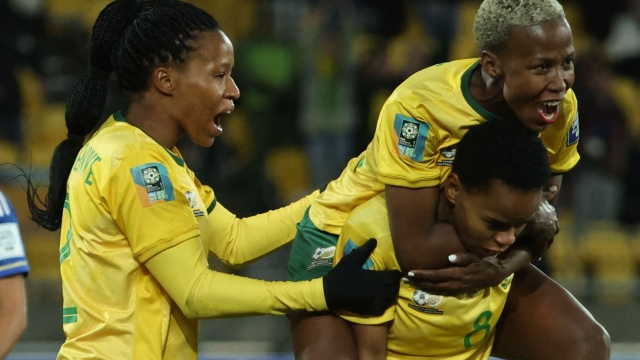 South Africa's forward #08 Hildah Magaia (R) is congratulated by teammates after scoring a goal during the Australia and New Zealand 2023 Women's World Cup Group G football match between South Africa and Italy at Wellington Stadium in Wellington on August 2, 2023. (Photo by Marty MELVILLE / AFP)