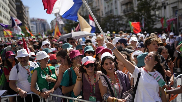 Worshipers gather as they wait for Pope Francis arriving at Lisbon's Parque Eduardo VII to preside over a 'Via Crucis' (Way of the Cross) with young people participating into Sunday's 37th World Youth Day in the Portuguese capital, Friday, Aug. 4, 2023. Francis is in Portugal through the weekend to preside over the jamboree that St. John Paul II launched in the 1980s to encourage young Catholics in their faith. (AP Photo/Armando Franca)