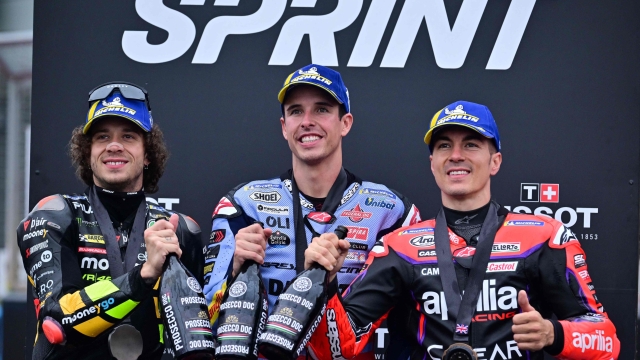 (From L) Second-placed Mooney VR46 Racing's Italian rider Marco Bezzecchi, first-placed Gresini Racing MotoGP's Spanish rider Alex Marquez and thrid-placed Aprilia Racing's Spanish rider Maverick Vinales celebrate duirng the podium ceremony after competing in the Moto GP sprint race of the motorcycling British Grand Prix at Silverstone circuit in Northamptonshire, central England, on August 5, 2023. (Photo by Ben Stansall / AFP)