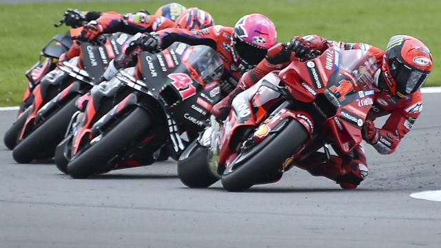 Italian rider Francesco Bagnaia of the Ducati Lenovo Team, right, steers his motorcycle followed by Spain's rider Aleix Espargaro of the Aprilia Racing during the MotoGP race of the British Motorcycle Grand Prix at the Silverstone racetrack, in Silverstone, England, Sunday, Aug. 6, 2023. (AP Photo/Rui Vieira)