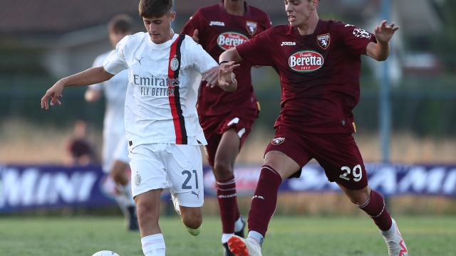 QUATTORDIO, ITALY - AUGUST 10: Mattia Liberali (L) of AC Milan competes for the ball during the Trofeo Mamma Cairo match between AC Milan U19 and Torino FC U19 on August 10, 2023 in Quattordio, Italy. (Photo by AC Milan/AC Milan via Getty Images)