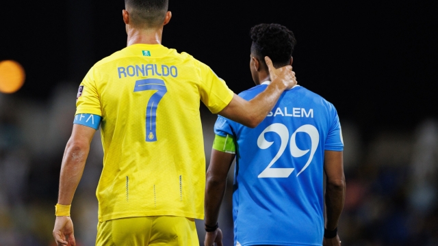 Nassr's Portuguese forward #07 Cristiano Ronaldo speaks with Hilal's Saudi midfielder #29 Salem al-Dawsari during the 2023 Arab Club Champions Cup final football match between Saudi Arabia's Al-Hilal and Al-Nassr at the King Fahd Stadium in Taif on August 12, 2023. (Photo by AFP)