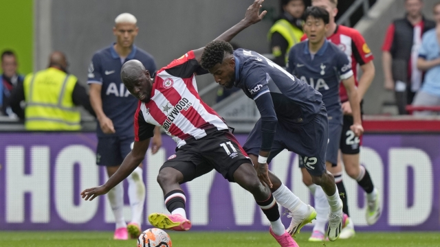 Brentford's Yoane Wissa, left and Tottenham's Emerson Royal challenge for the ball during an English Premier League soccer match between Brentford and Tottenham Hotspur at the Community Stadium in London, Sunday, Aug. 13, 2023. (AP Photo/Frank Augstein)