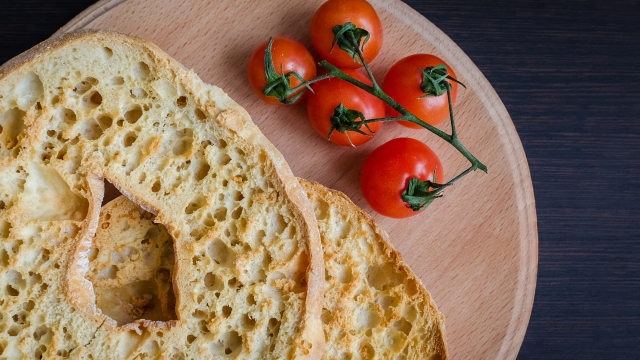Italian dried bread Friselle on wooden board with tomatoes cherry. Italian food. Healthy vegetarian food.