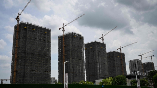 (FILES) A general view shows Evergrande residential buildings under construction in Guangzhou, in Chinas southern Guangdong province on July 18, 2022. Embattled Chinese property giant Evergrande Group filed for bankruptcy protection in the United States on August 17, 2023, court documents showed, a measure that protects its US assets while it attempts to restructure. (Photo by JADE GAO / AFP)