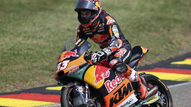 Turkish rider Deniz Oncu of the Red Bull KTM Ajo, rides his bike after crossing the finish line to win the Moto 3 race of the German Grand Prix, in Hohenstein-Ernstthal, Germany, Sunday, June 18, 2023. (Jan Woitas/dpa via AP)