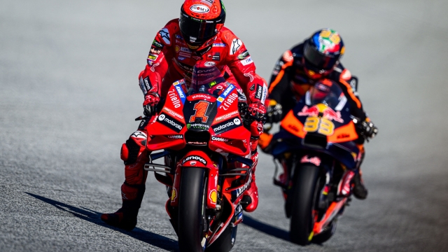 Ducati Lenovo Team Italian rider Francesco Bagnaia (L) and Red Bull KTM Factory Racing South African rider Brad Binder compete during the sprint race at the Red Bull Ring race track in Spielberg, Austria on August 18, 2023, ahead of the MotoGP Austrian Grand Prix. (Photo by Jure Makovec / AFP)