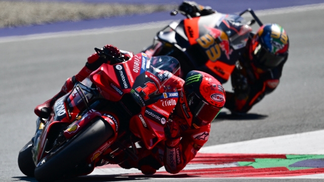 Ducati Lenovo Team Italian rider Francesco Bagnaia (L) and Red Bull KTM Factory Racing South African rider Brad Binder at the start of the MotoGP Austrian Grand Prix at the Red Bull Ring racetrack in Spielberg bei Knittelfeld, Austria, on August 20, 2023. (Photo by Jure Makovec / AFP)