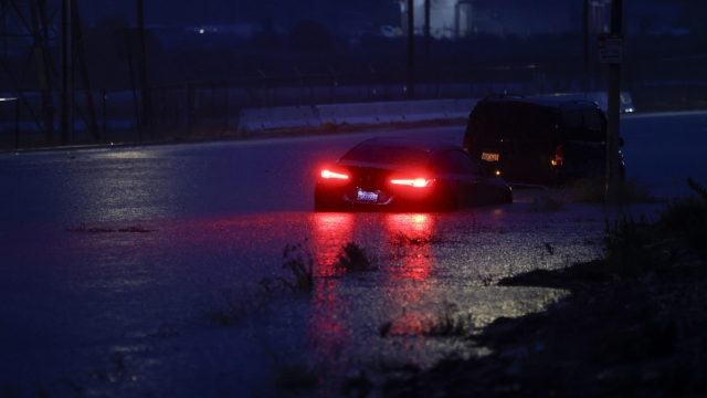 epa10811188 A car is half submerged in water on the side of a road in Santa Clarita, California, USA, 20 August 2023. Southern California is under a tropical storm warning for the first time in history as Hilary makes landfall. The last time a tropical storm made landfall in Southern California was 15 September 1939, according to the National Weather Service.  EPA/CAROLINE BREHMAN