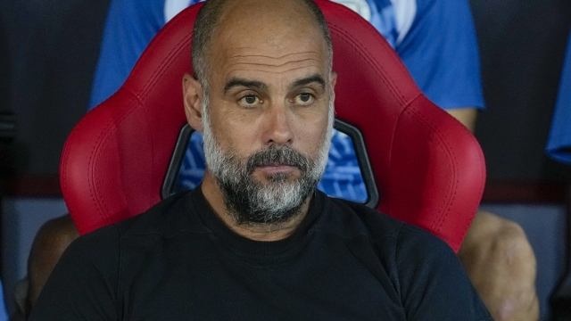 Manchester City's head coach Pep Guardiola looks out from the bench ahead of the UEFA Super Cup Final soccer match between Manchester City and Sevilla at Georgios Karaiskakis stadium in Piraeus port, near Athens, Greece, Wednesday, Aug. 16, 2023. (AP Photo/Thanassis Stavrakis)