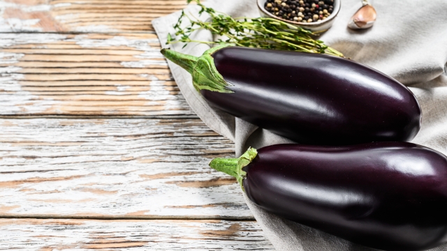 Raw purple eggplant. Organic vegetables. White background. Top view. Copy space.