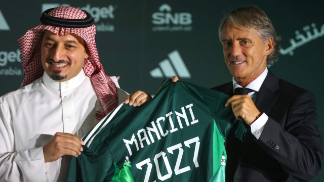 The president of the Saudi Arabian Football Federation, Yasser al-Misehal (L) and newly appointed Italian coach of the Saudi national football team, Roberto Mancini, pose for a picture at a press conference and signing ceremony in Riyadh, on August 28, 2023. Mancini was yesterday named as the new coach of the Saudi Arabia national team on a deal reported to be worth more than $25 million a year after he controversially quit the Italy job earlier this month. (Photo by Fayez NURELDINE / AFP)