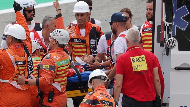 Ducati Italian rider Francesco Bagnaia is taken into an ambulance on a stretcher after a fall during the MotoGP race of the Moto Grand Prix de Catalunya at the Circuit de Catalunya in Montmelo, on the outskirts of Barcelona, on September 3, 2023. (Photo by LLUIS GENE / AFP)