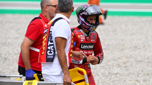 Ducati Italian rider Enea Bastianini receives assistance after a fall during the MotoGP race of the Moto Grand Prix de Catalunya at the Circuit de Catalunya in Montmelo, on the outskirts of Barcelona, on September 3, 2023. (Photo by Josep LAGO / AFP)