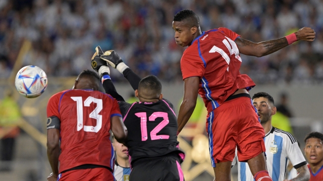 Panama's defenders Jiovany Ramos (L) and Gilberto Hernandez (R) jump for the ball with goalkeeper Jose Guerra to clear the ball from the goal during the friendly football match between Argentina and Panama at the Monumental stadium in Buenos Aires on March 23, 2023. Hernandez was shot dead by unknown gunmen in the Panamanian Caribbean city of Colon on September 3, 2023, and a suspect was arrested, police informed on September 4. The 26-year-old defender died Sunday afternoon when he and six other people were gunned down by unknown assailants in a car in a city where crime rates have risen due to apparent disputes between drug gangs. (Photo by Juan MABROMATA / AFP)