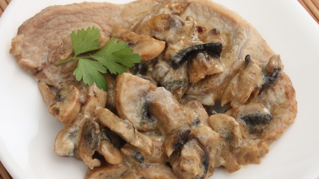 Veal escalope cooked in cream Mushrooms of Paris French cooking