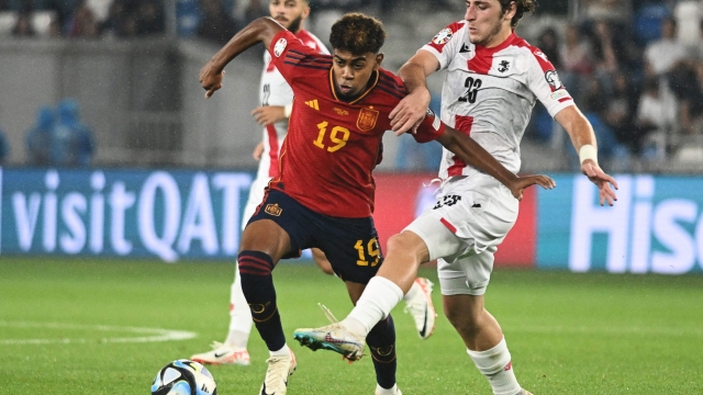Spain's Lamine Yamal (L) and Georgia's Georgia's midfielder Luka Gagnidze fight for the ball  during the UEFA Euro 2024 qualifying first round group A football match between Georgia and Spain in Tbilisi on September 8, 2023. (Photo by Vano SHLAMOV / AFP)