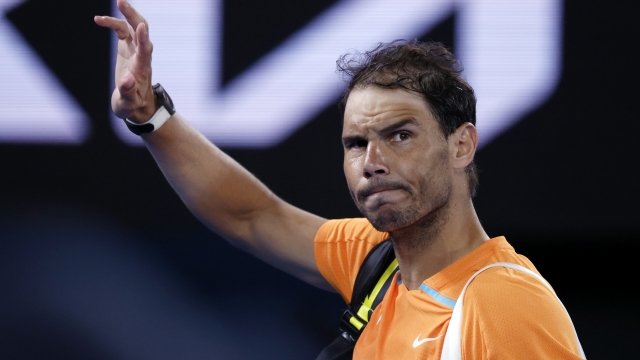Rafael Nadal of Spain waves as he leaves Rod Laver Arena following his second round loss to Mackenzie McDonald of the U.S. at the Australian Open tennis championship in Melbourne, Australia, Wednesday, Jan. 18, 2023. (AP Photo/Asanka Brendon Ratnayake)