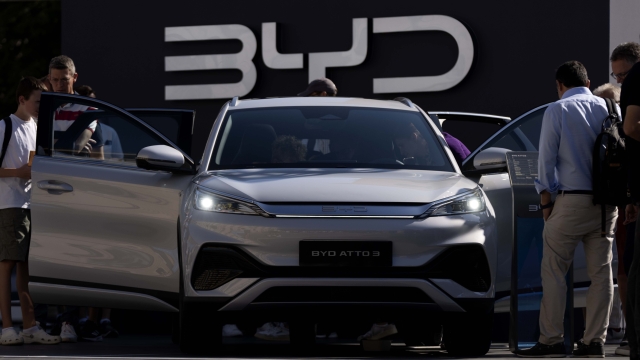 Visitors watch the BYD ATTO 3 at the IAA motor show in Munich, Germany, Friday, Sept. 8, 2023. The international motor show IAA Mobility 2023 takes place in Munich from Sept. 5 until Sept. 10, 2023. (AP Photo/Matthias Schrader)