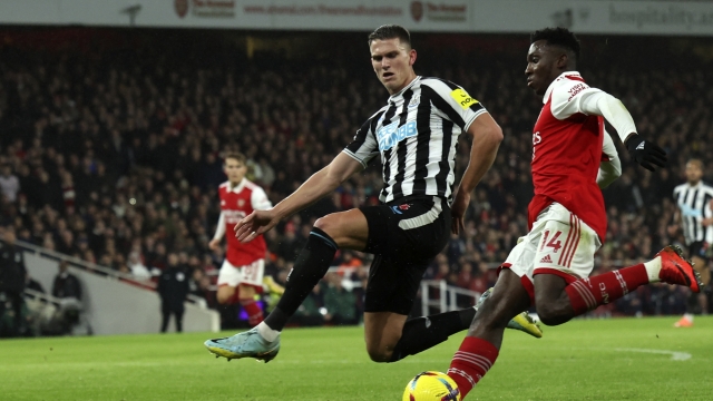 Newcastle's Sven Botman, left, tries to block a shot from Arsenal's Eddie Nketiah during the English Premier League soccer match between Arsenal and Newcastle United at Emirates stadium in London, Tuesday, Jan. 3, 2023. (AP Photo/Ian Walton)