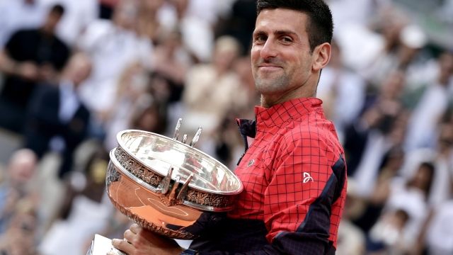 epa10685629 Novak Djokovic of Serbia poses with the  Coupe des Mousquetaires after winning against Casper Ruud of Norway in their Men's final match during the French Open Grand Slam tennis tournament at Roland Garros in Paris, France, 11 June 2023.  EPA/CHRISTOPHE PETIT TESSON