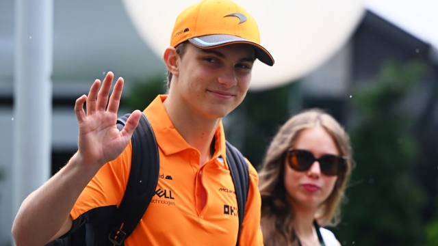 SINGAPORE, SINGAPORE - SEPTEMBER 16: Oscar Piastri of Australia and McLaren and Lily Zneimer walk in the Paddock ahead of final practice ahead of the F1 Grand Prix of Singapore at Marina Bay Street Circuit on September 16, 2023 in Singapore, Singapore. (Photo by Clive Mason/Getty Images)