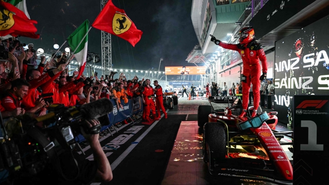 TOPSHOT - Ferrari's Spanish driver Carlos Sainz Jr celebrates winning the Singapore Formula One Grand Prix night race at the Marina Bay Street Circuit in Singapore on September 17, 2023. (Photo by MOHD RASFAN / AFP)