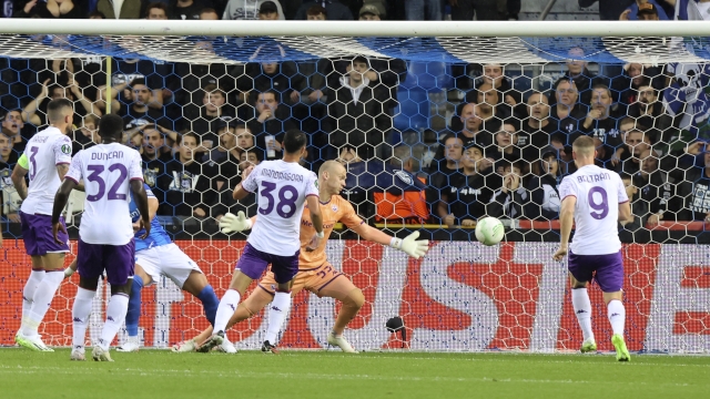 The ball gets past Fiorentina's goalkeeper Oliver Christensen, center, scored by Genk's Andi Zeqiri during the Europa Conference League Group F soccer match between KRC Genk and AFC Fiorentina at the Genk Arena in Genk, Belgium, Thursday, Sept. 21, 2023. (AP Photo/Francois Walschaerts)