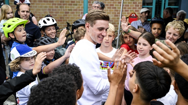 Belgian Remco Evenepoel of Soudal Quick-Step is surrounded by young fans during the Kids on Wheelz initiative after the first edition of the R.EV Ride, Schepdaal, Dilbeek on July 1, 2023, which follows Evenepoel's favourite training routes through the Pajottenland, the Flemish Ardennes and the Pays des Collines. (Photo by Tom Goyvaerts / Belga / AFP) / Belgium OUT