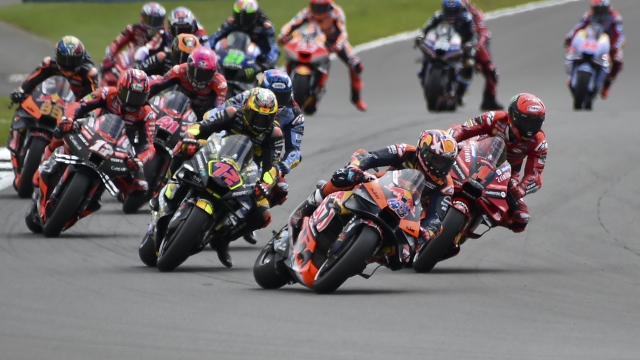 Australian rider Jack Miller of the Red Bull KTM Factory Racing leads the pack at the start of the MotoGP race of the British Motorcycle Grand Prix at the Silverstone racetrack, in Silverstone, England, Sunday, Aug. 6, 2023. (AP Photo/Rui Vieira)