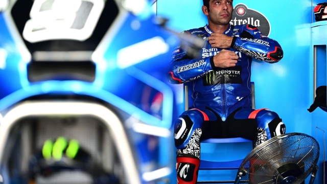 Suzuki Ecstar's Italian rider Danilo Petrucci sits in the pit during the third free practice session of the MotoGP Thailand Grand Prix at Buriram International Circuit in Buriram on October 1, 2022. (Photo by Manan VATSYAYANA / AFP)