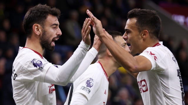 BURNLEY, ENGLAND - SEPTEMBER 23: Bruno Fernandes of Manchester United celebrates with team mate Sergio Reguilon after scoring their sides first goal during the Premier League match between Burnley FC and Manchester United at Turf Moor on September 23, 2023 in Burnley, England. (Photo by Lewis Storey/Getty Images)