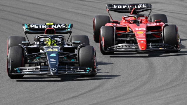 Mercedes' British driver Lewis Hamilton (L) and Ferrari's Monegasque driver Charles Leclerc drive during the Dutch Formula One Grand Prix race at The Circuit Zandvoort, in Zandvoort on August 27, 2023. (Photo by JOHN THYS / AFP)