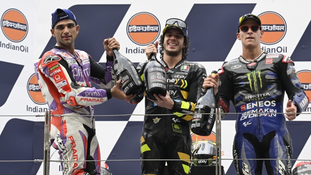 DELHI, INDIA - SEPTEMBER 24: Jorge Martin of Spain and Prima Pramac Racing team (L, second place), Marco Bezzecchi of Italy and  Mooney VR46 Racing Team (C, First place) and Fabio Quartararo of France and Monster Energy Yamaha team (R, third place) pose for media on podium after MotoGP race of the Indian MotoGP Grand Prix at the Buddh International Circuit in Greater Noida on the outskirts of New Delhi, on September 24, 2023. (Photo by Prakash Singh/Getty Images)