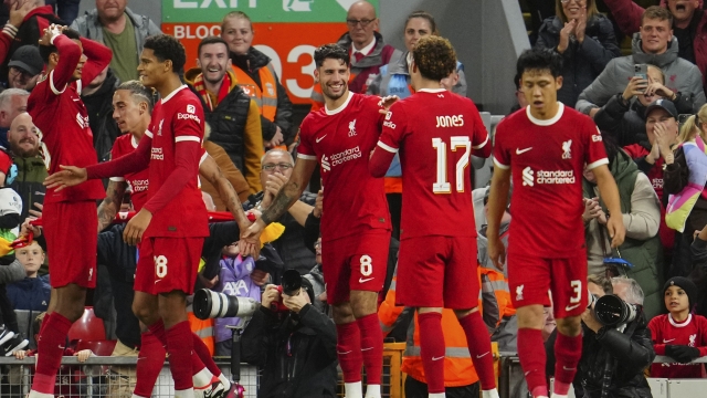Liverpool's Dominik Szoboszlai, center, celebrates after scoring his side's second goal during the English League Cup third round soccer match between Liverpool and Leicester City at the Anfield stadium in Liverpool, England, Wednesday, Sept. 27, 2023. (AP Photo/Jon Super)