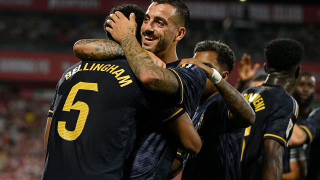 Real Madrid's English midfielder #5 Jude Bellingham celebrates with Real Madrid's Spanish forward #14 Joselu after scoring his team's third goal during the Spanish Liga football match between Girona FC and Real Madrid CF at the Montilivi stadium in Girona on September 30, 2023. (Photo by Josep LAGO / AFP)