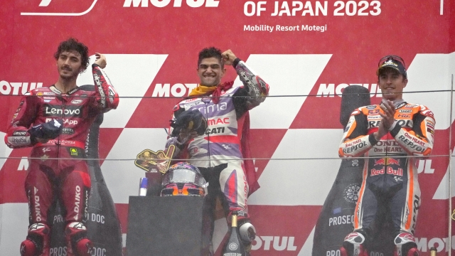 Spain's Jorge Martin, center, celebrates, flanked by second placed Italy's Francesco Bagnaia, left, and third placed Spanish rider Marc Marquez, right, on the podium after winning the MotoGP race of Japanese Motorcycle Grand Prix at the Twin Ring Motegi circuit in Motegi, north of Tokyo Sunday, Oct. 1, 2023.(AP Photo/Shuji Kajiyama)