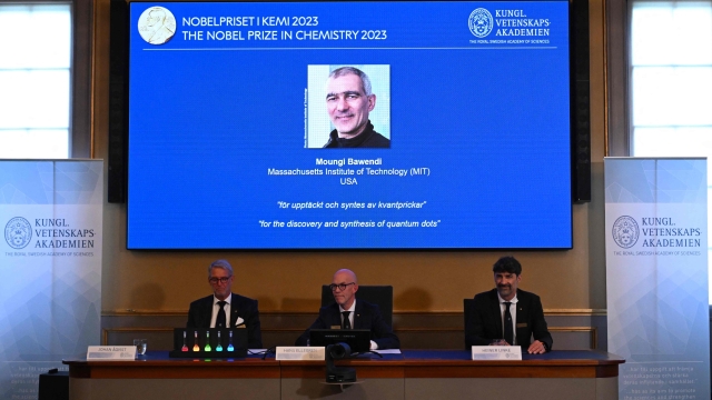 A screen shows one of this year's laureates US Chemist Moungi Bawendi as he speaks via phone to the media during the announcement of the winners of the 2023 Nobel Prize in chemistry at Royal Swedish Academy of Sciences in Stockholm on October 4, 2023. French-born Moungi Bawendi, Louis Brus of the United States and Russian-born Alexei Ekimov won the Nobel Chemistry Prize for research in semiconductor nanocrystals known as quantum dots. (Photo by Jonathan NACKSTRAND / AFP)