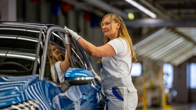 epa10650176 A Volkswagen employee completes a quality control inspection on an ID.3 automobile on the electric cars production line following assembly at the Volkswagen (VW) vehicle factory in Zwickau, Germany, 24 May 2023. The plant in Zwickau, completely re-equipped for electric mobility for a total of 1.2 billion euros, produces exclusively all-electric vehicles and has become the largest and highest-performance electric car plant in Europe for the Volkswagen group.  EPA/MARTIN DIVISEK