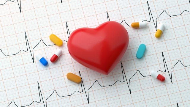 3D Heart and Pills On On Heart Rhythm Background Concept