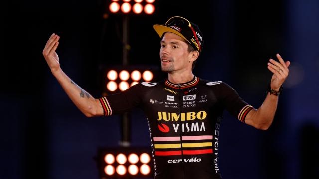 Team Jumbo's Slovenian rider Primoz Roglic celebrates on the podium after the 21st and last stage of the 2023 La Vuelta cycling tour of Spain, a 101,1 km race between the hippodrome of La Zarzuela and Madrid, on September 17, 2023. American rider Sepp Kuss claimed his first Grand Tour victory in the Vuelta a Espana in Madrid, as his team Jumbo-Visma completed an unprecedented treble. (Photo by Oscar DEL POZO / AFP)